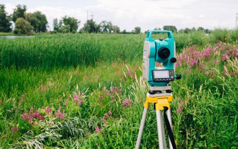 Surveying equipment on a field background